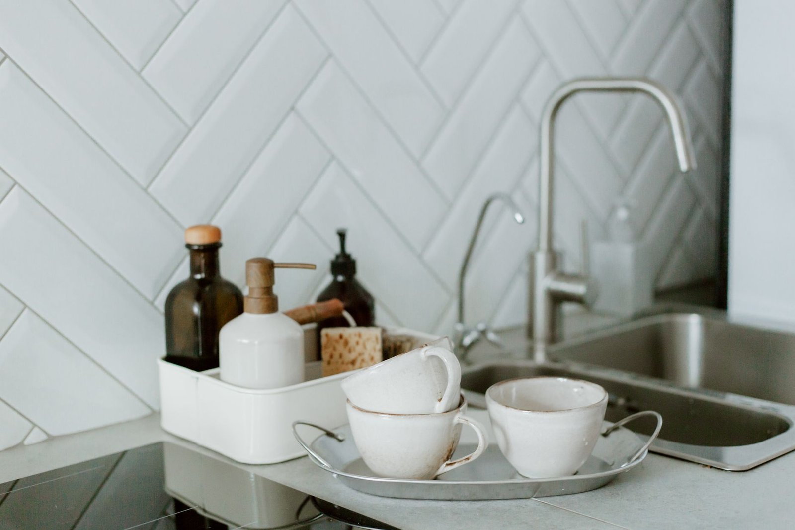 A sleek, uncluttered modern kitchen counter illuminated by warm under-cabinet lighting.