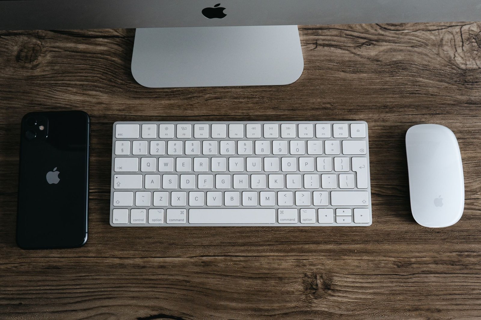 A clean wooden desk setup with natural light and simple accessories.