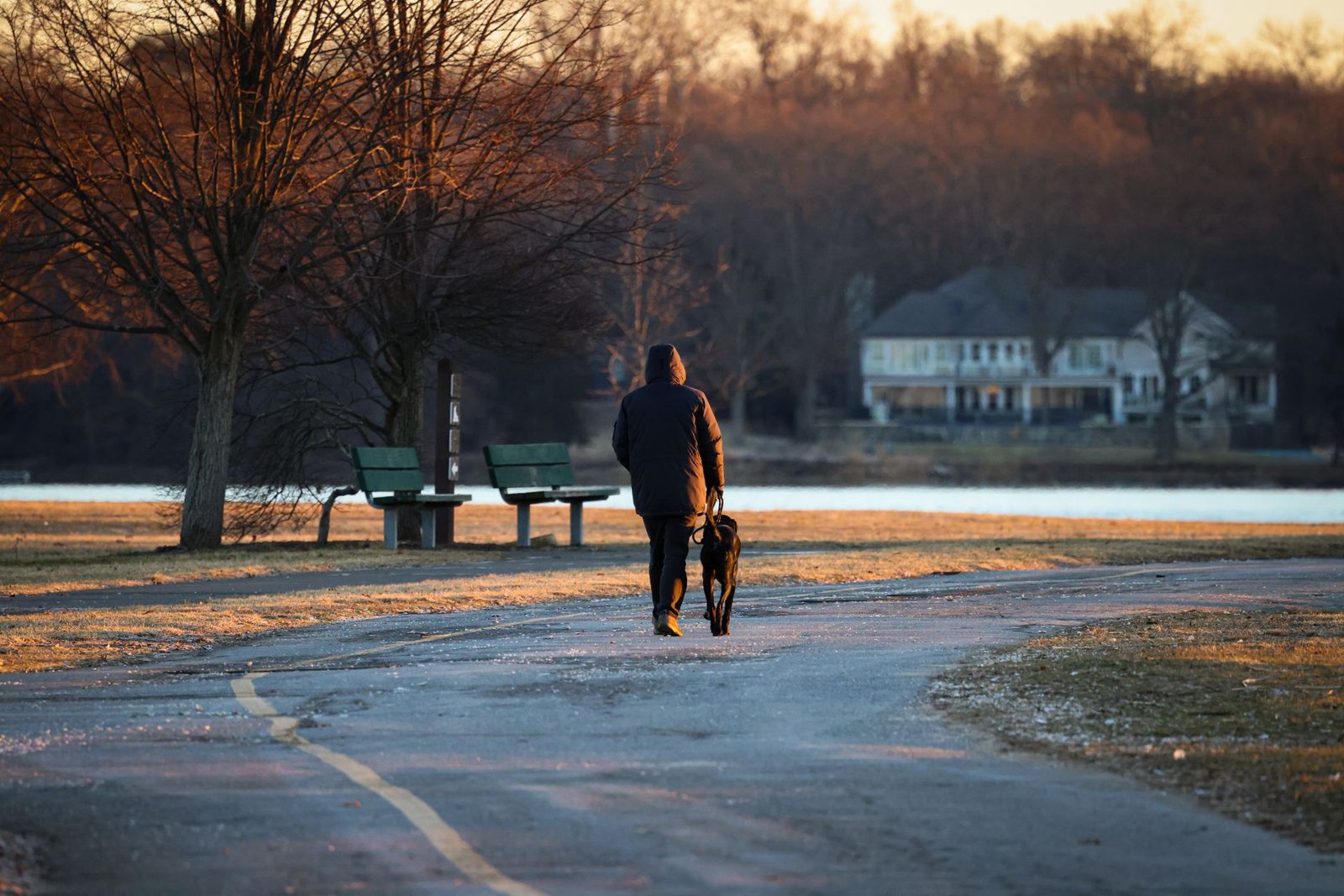 A person taking a peaceful evening walk in a park to transition from work.