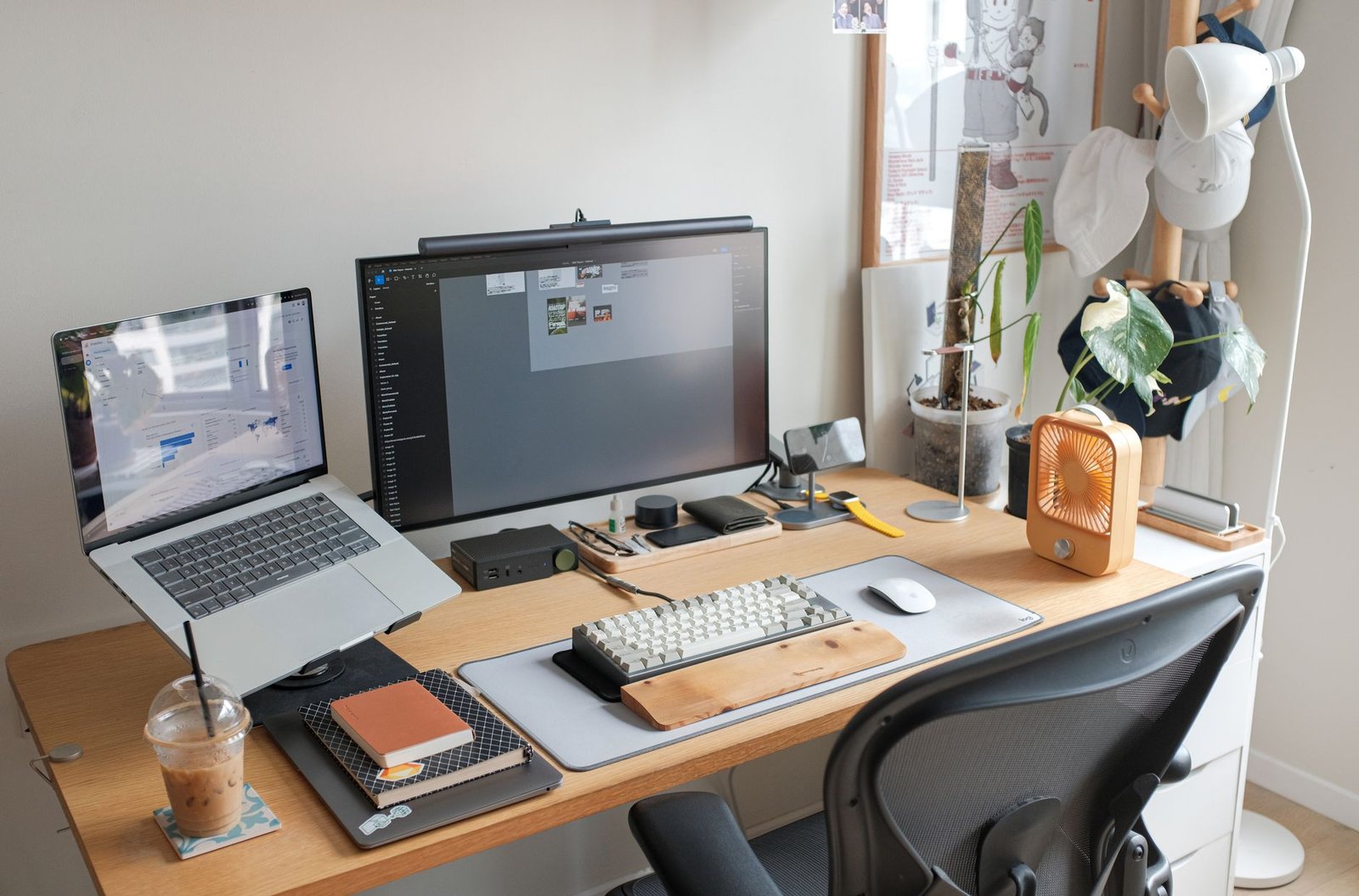 A clean minimalist home office desk setup featuring a laptop and organized notes.