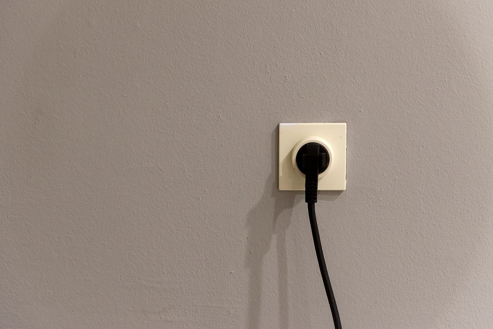 Smart plug plugged into a clean white wall outlet.