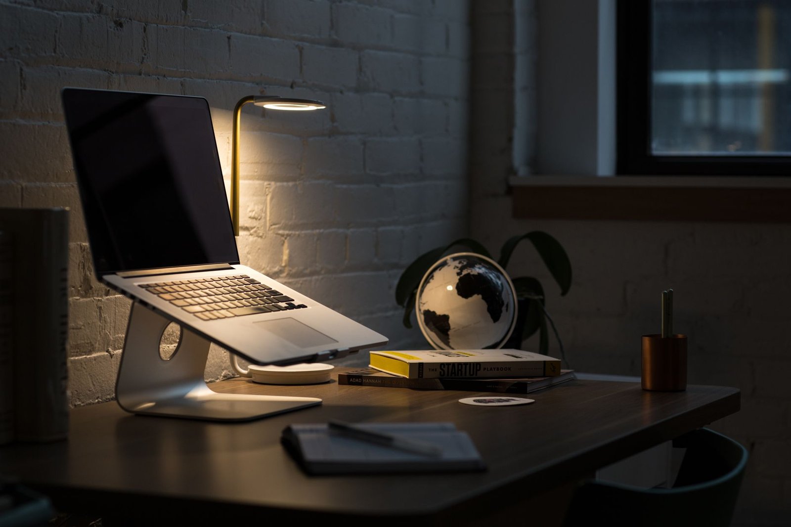 Modern ergonomic home office workspace with laptop and external monitor.