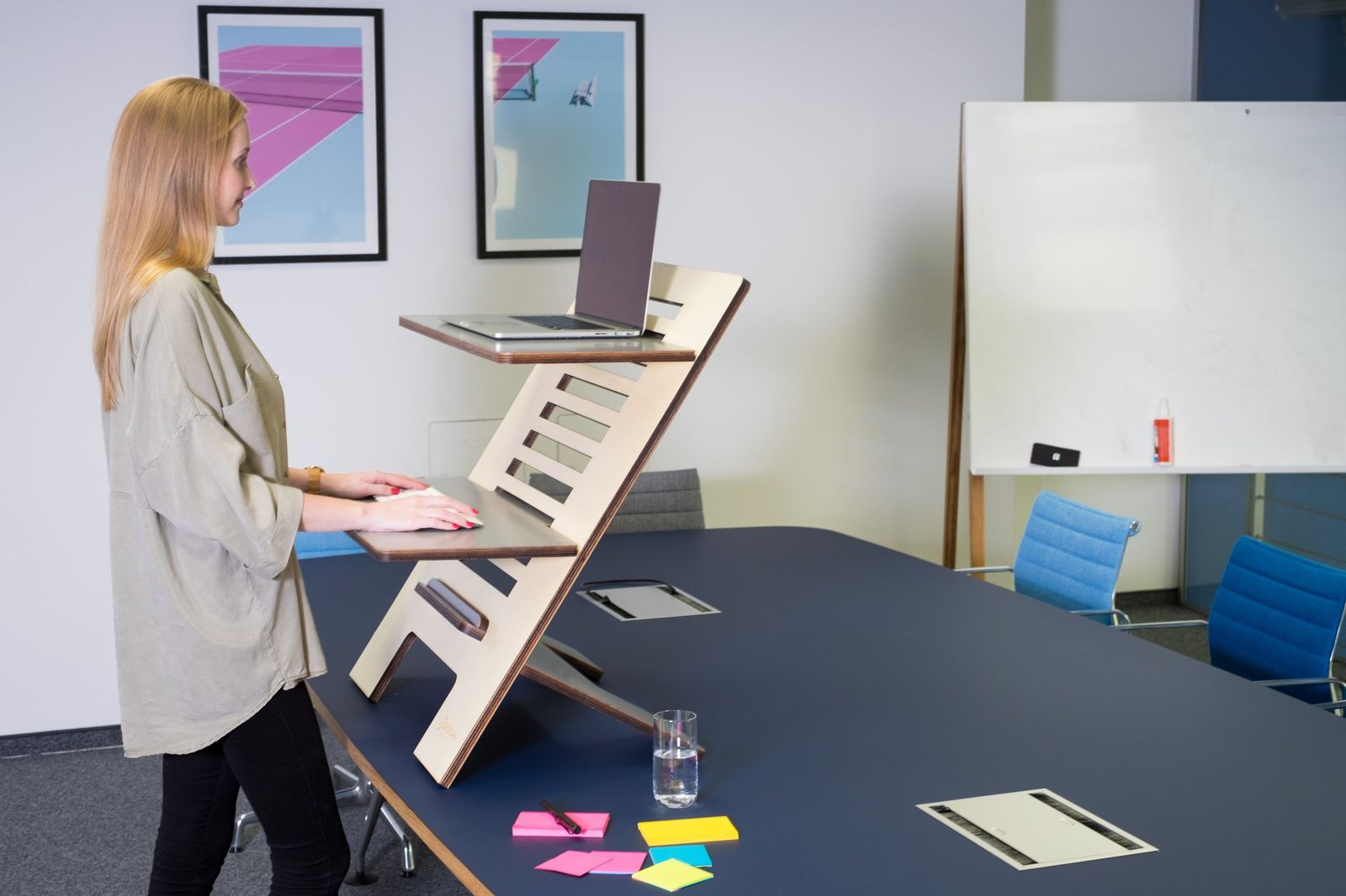Proper sitting posture alignment measured against an adjustable desk.