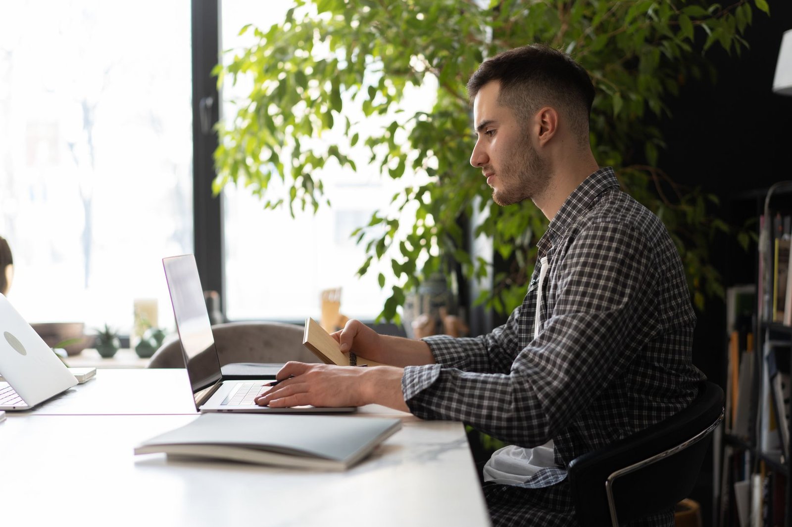 Knowledge worker focusing on text editing without mobile distractions nearby.