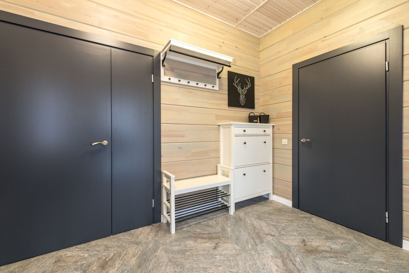 A tidy wooden entryway bench with neat rows of shoes underneath.
