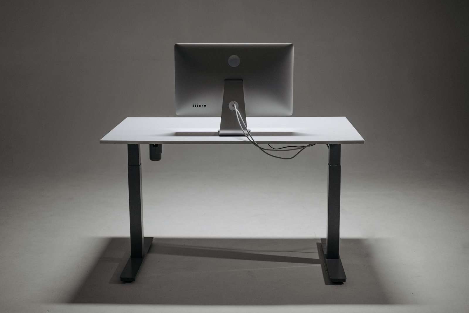 Under-mounted metal cable rack routing power cords cleanly.