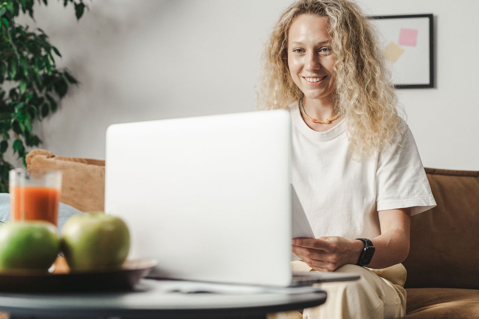 Professional working happily from home with an organized desk and premium tech setup.
