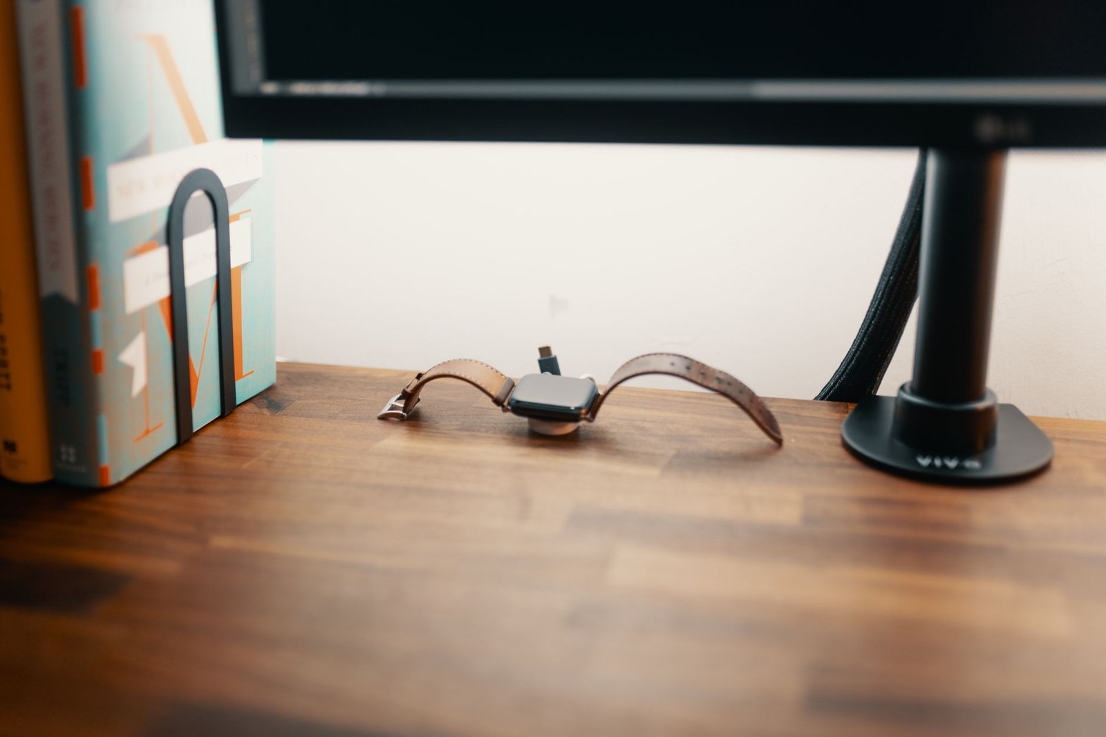 Clean modern desk setup featuring multi-port charging station and ergonomic accessories.
