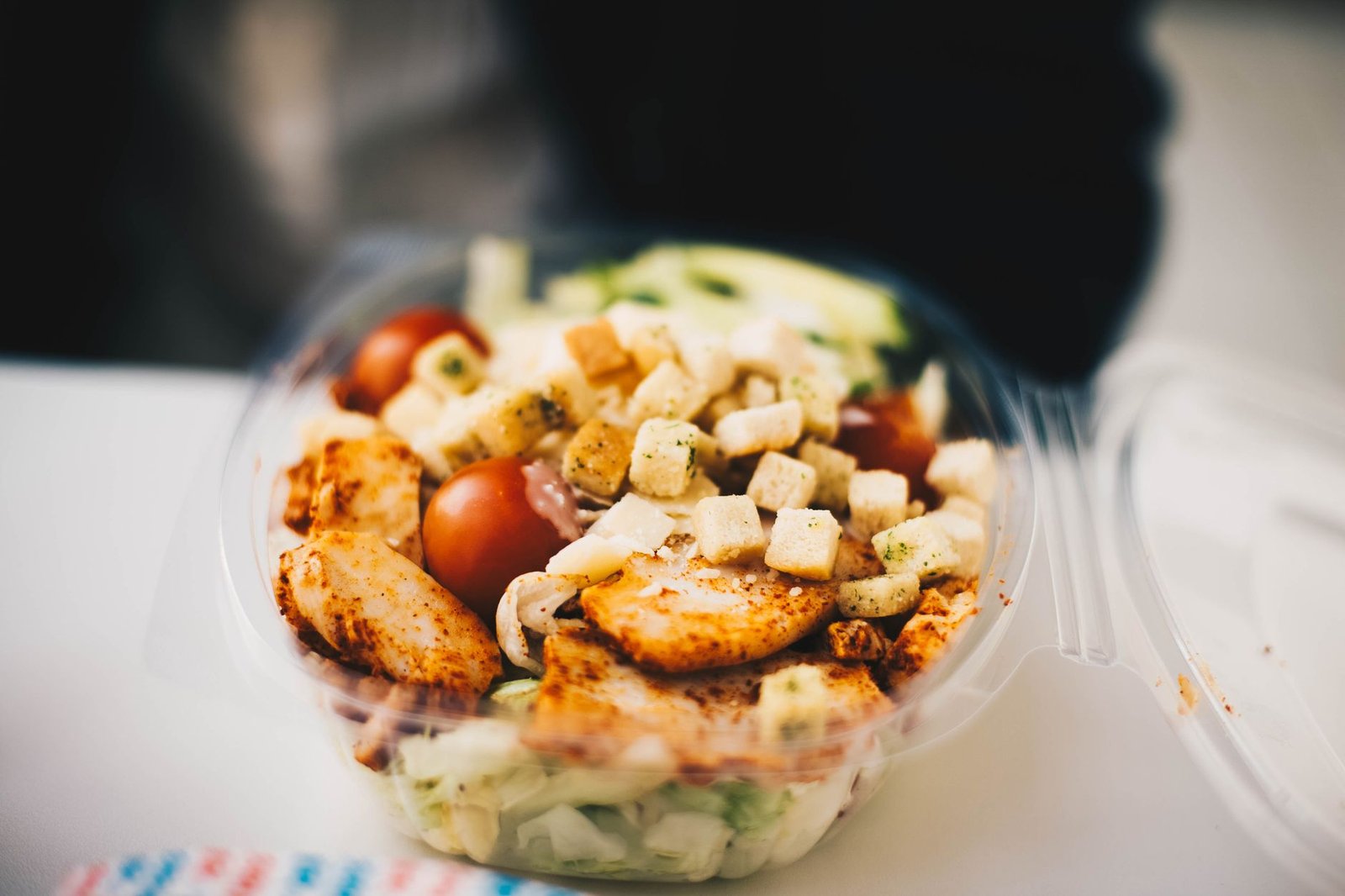Fresh meal prep container with protein, greens, and healthy fats.