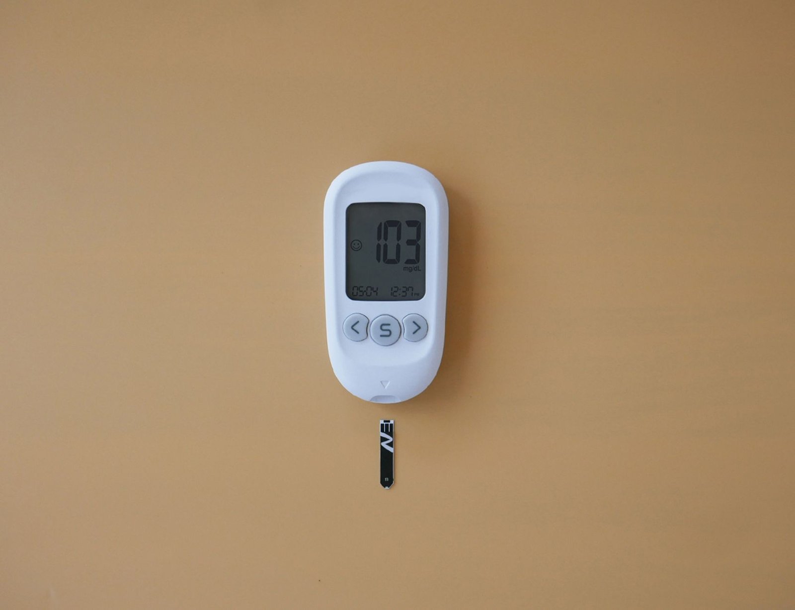 A person checking their glucose readings on a smartphone app.