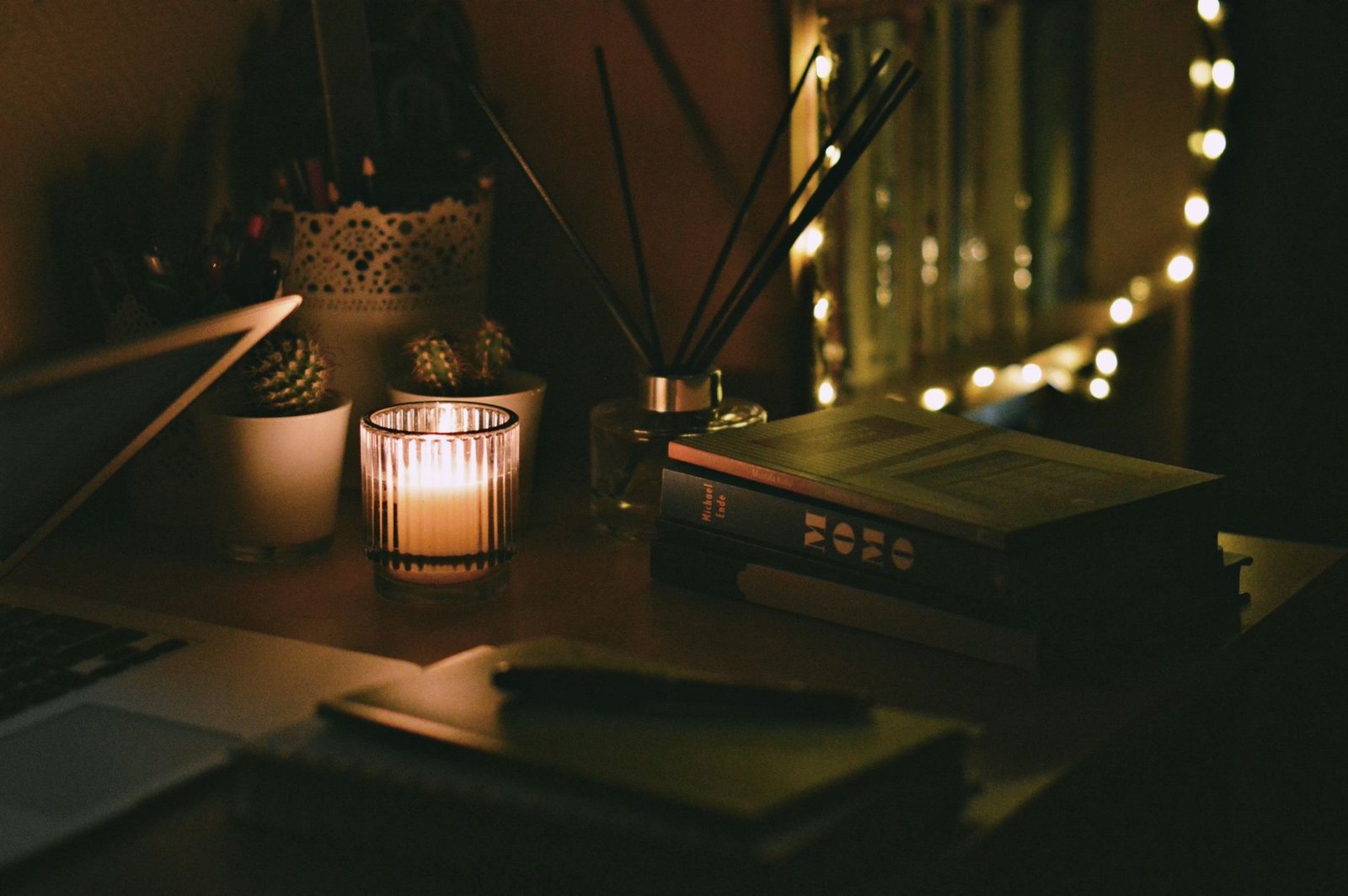 Peaceful remote workspace illuminated by soft warm desk lighting at dusk.