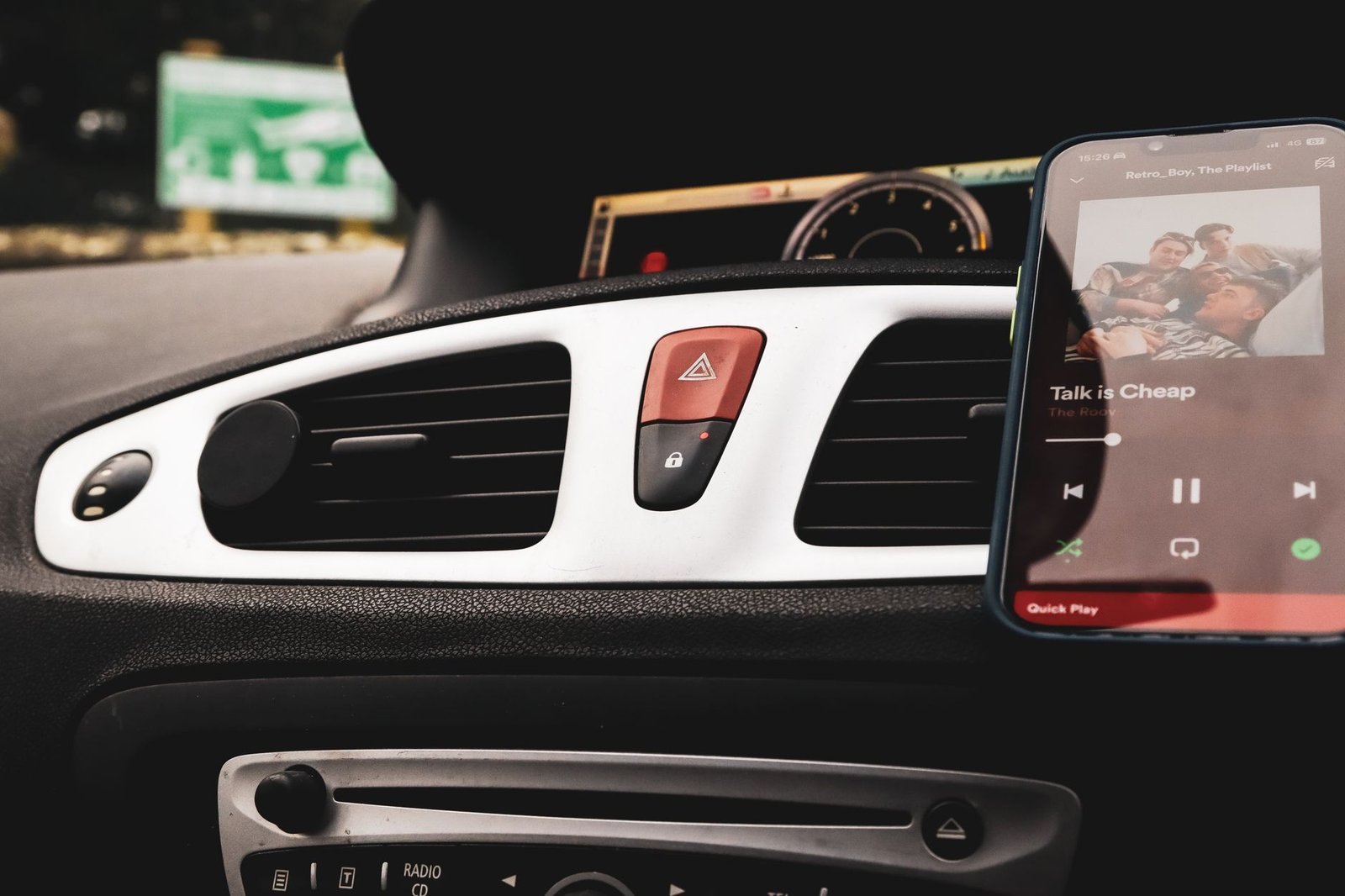 Smartphone mounted on a vehicle dashboard for handsfree navigation.