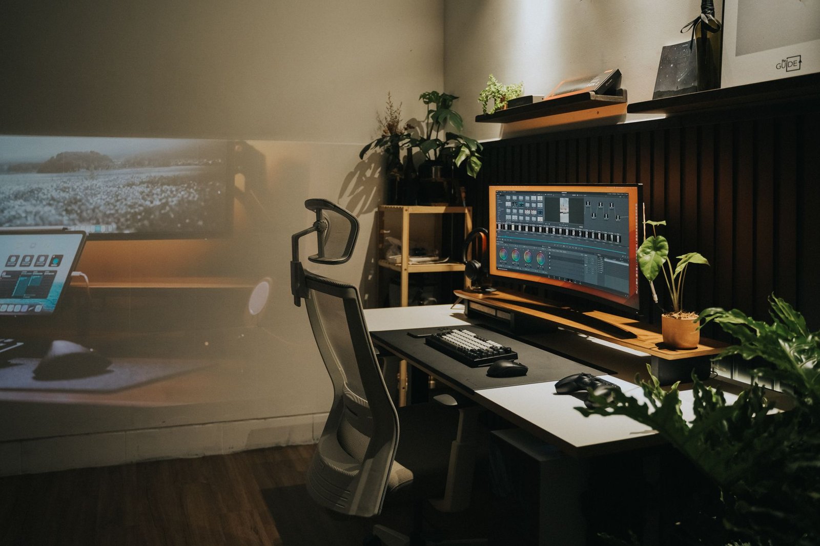 Man performing upper body stretches next to a standing desk setup.