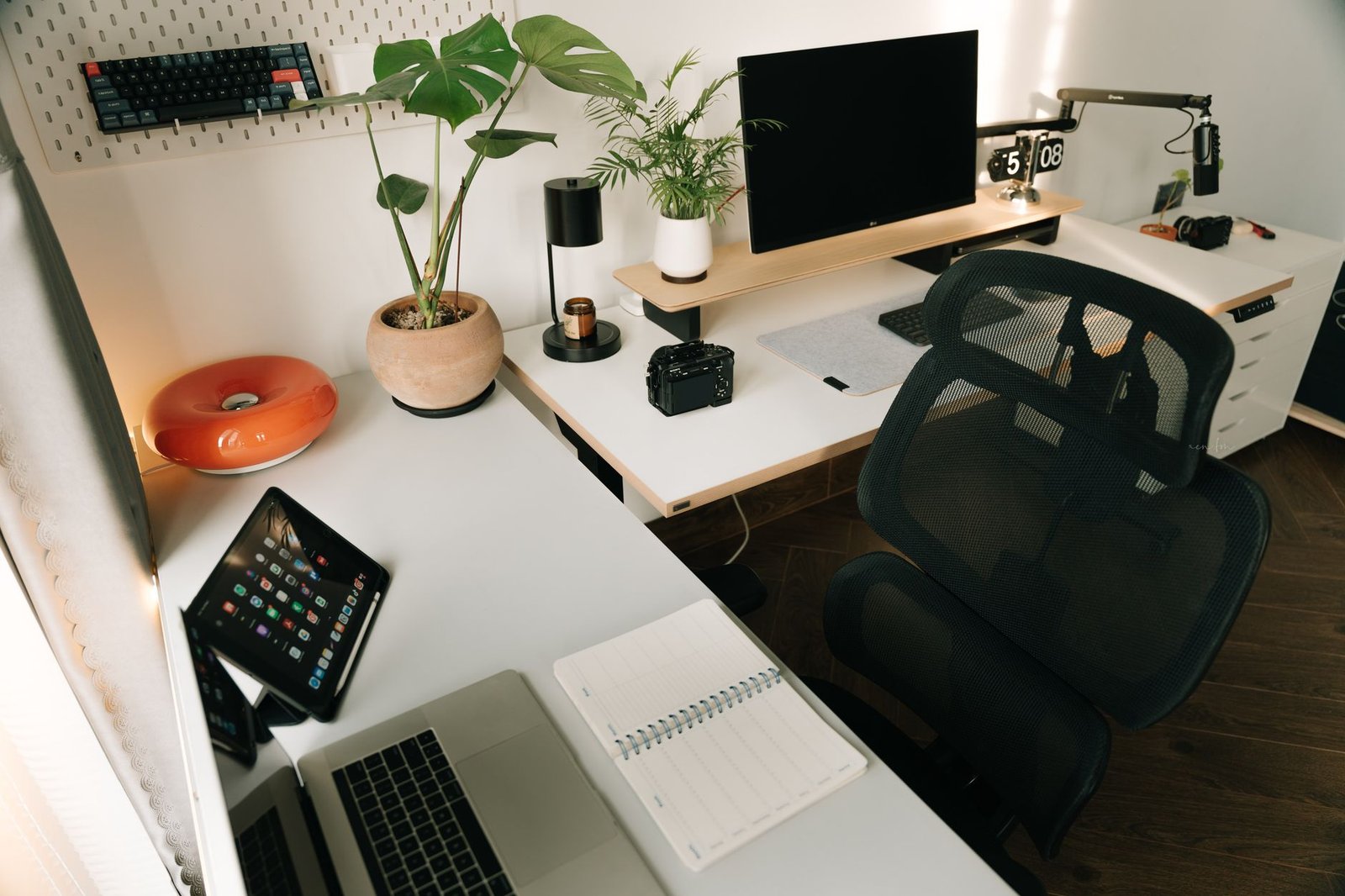 Clean minimalist desk setup with a single notebook and warm lighting.