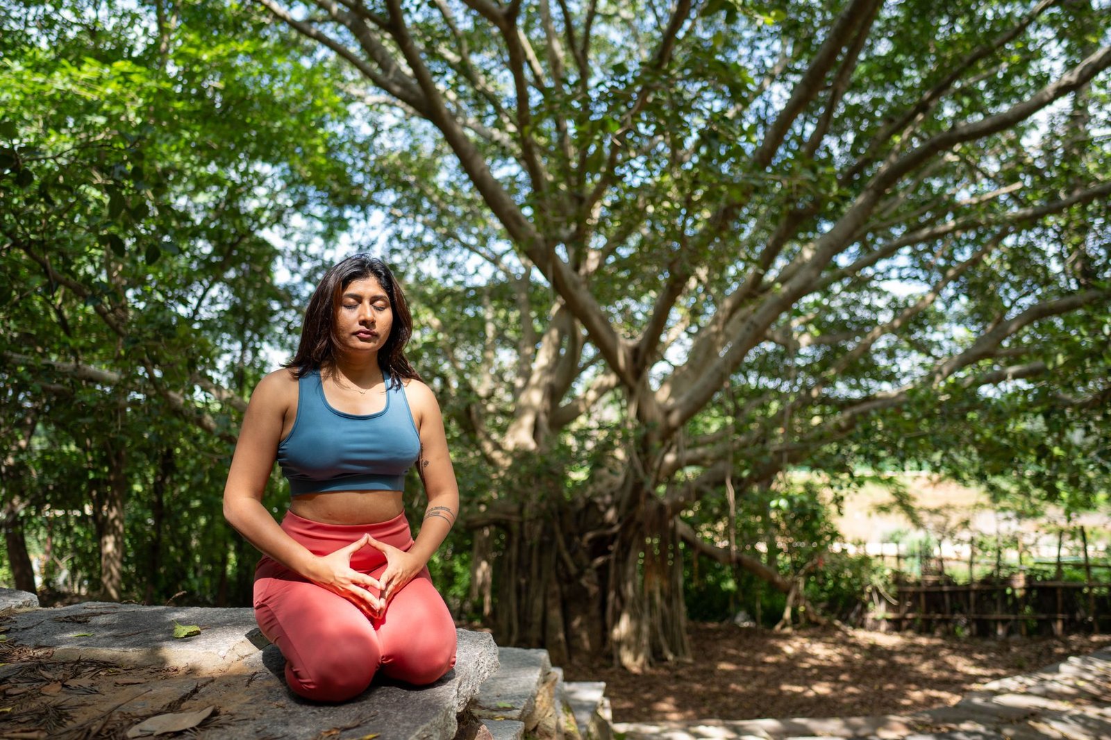 Professional worker practicing mindful breathing at a clean wooden desk.