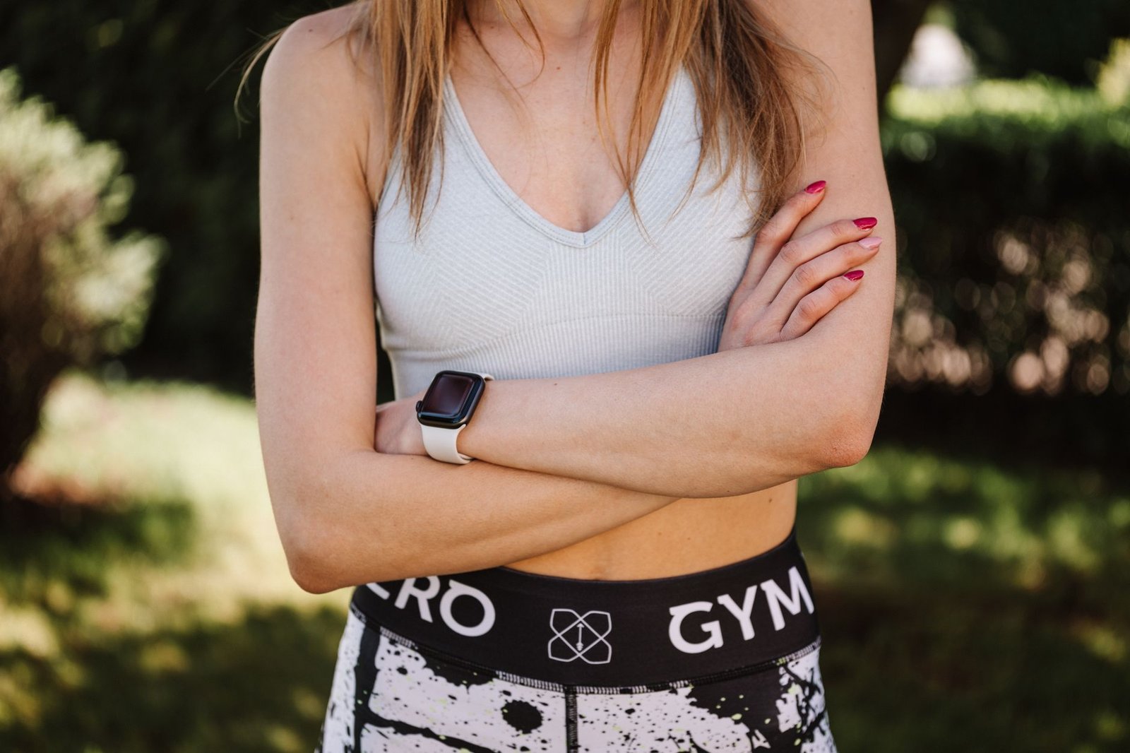 Modern smartwatch and wireless earbuds on a gym bench.