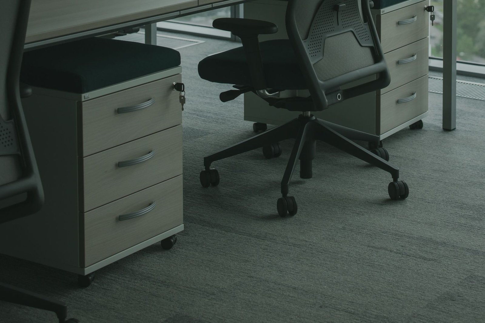 Clean minimalist desk setup featuring organized sliding storage beneath the wood surface.