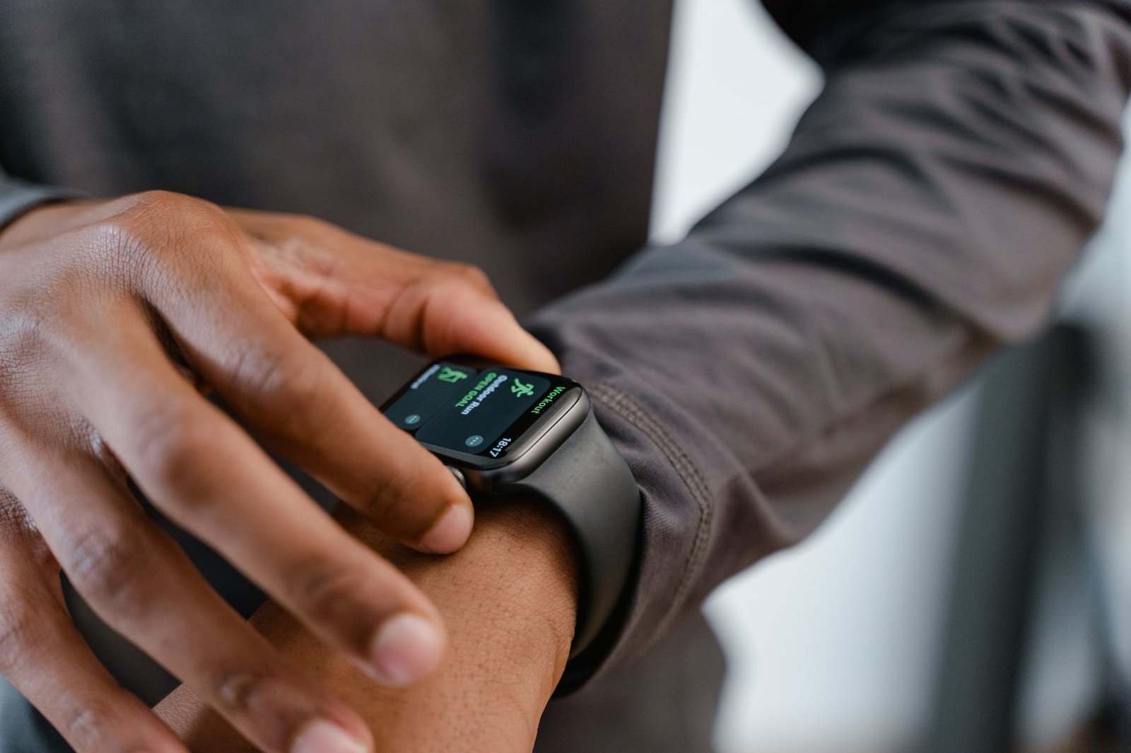 Close-up of a smartwatch displaying biometric health and recovery data on screen.